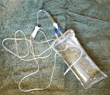 Fluid bag with drip line and needle attached