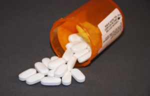 white pills spilling from a bottle